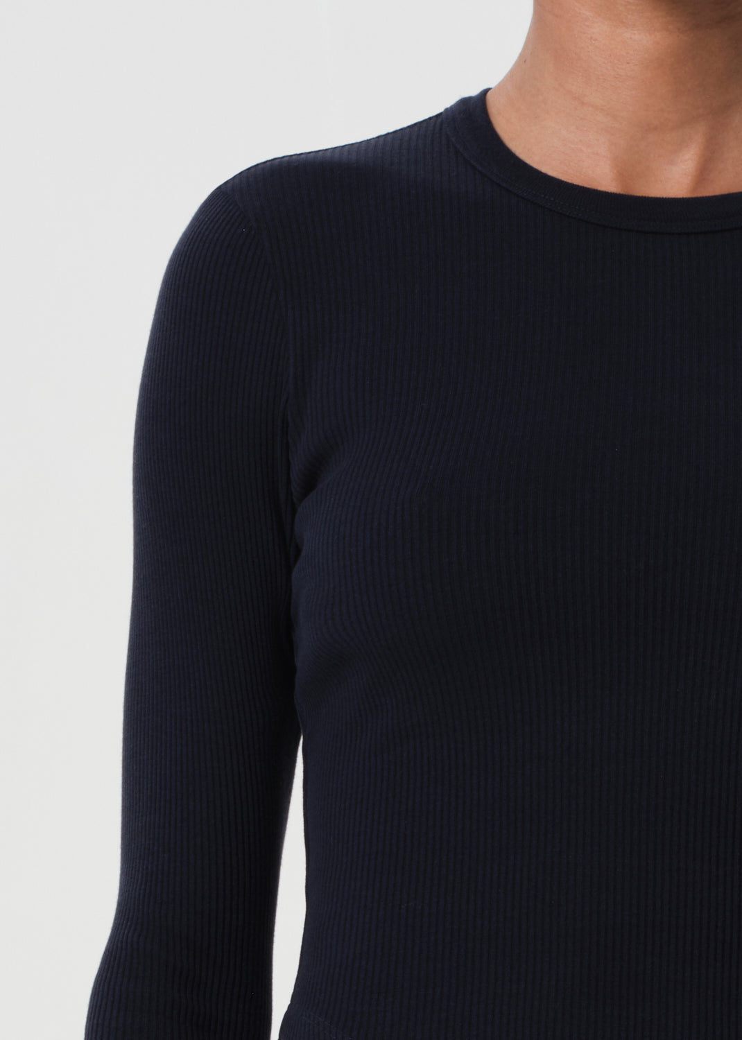 Black ribbed long-sleeve top on a plain background