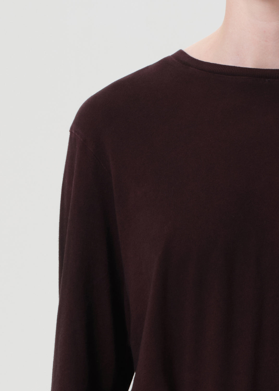 Brown long-sleeve shirt on a light gray background