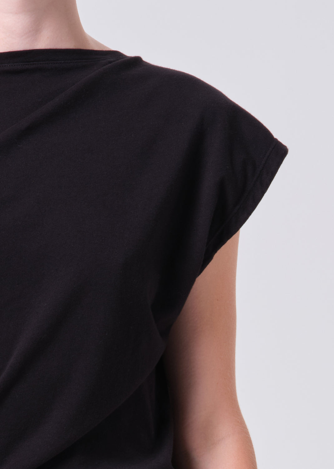 Black sleeveless top on a plain background