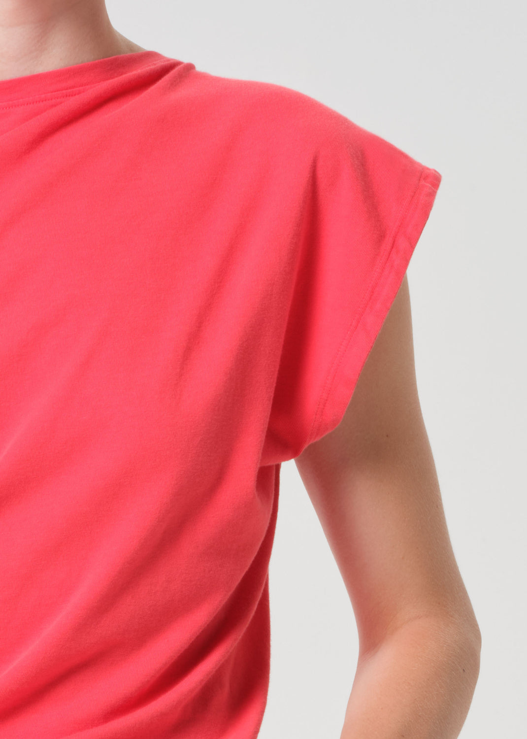 Red sleeveless top on a plain background