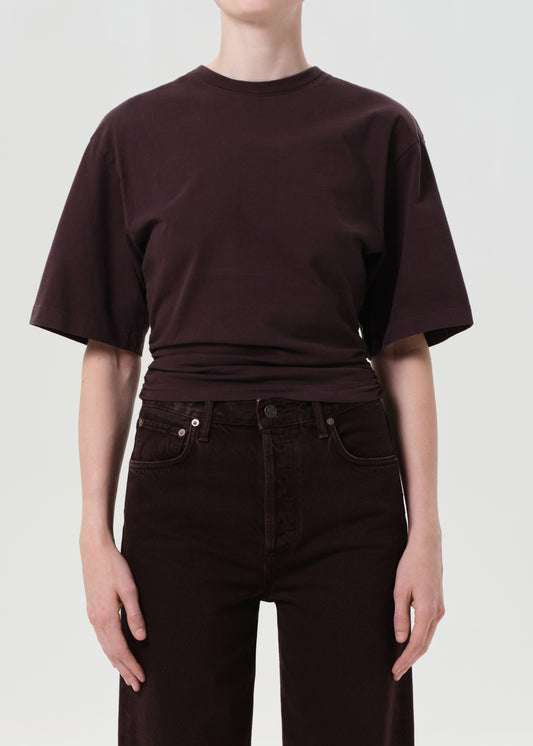 Person wearing a dark brown t-shirt and pants on a white background