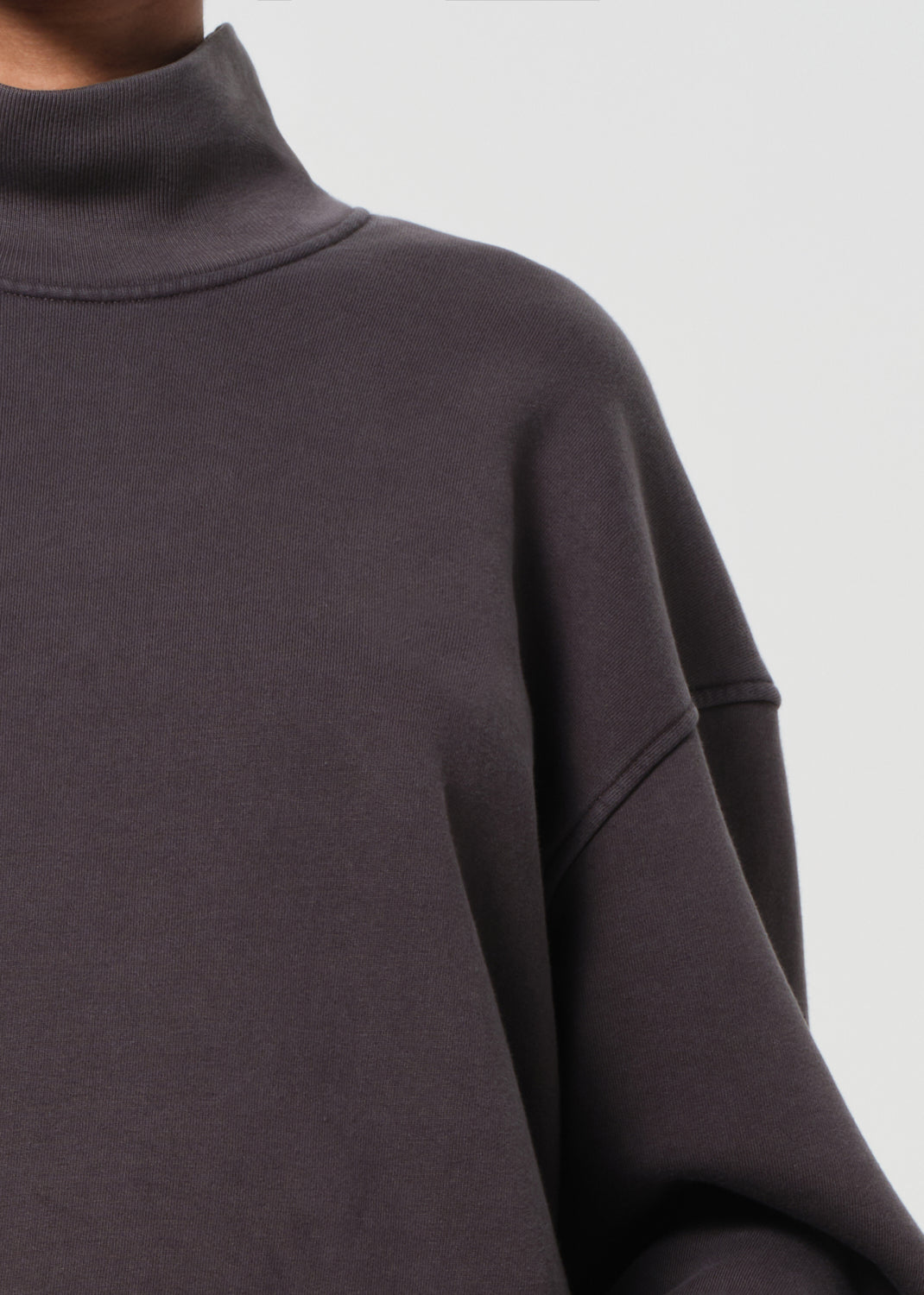 Dark gray turtleneck sweater on a light gray background