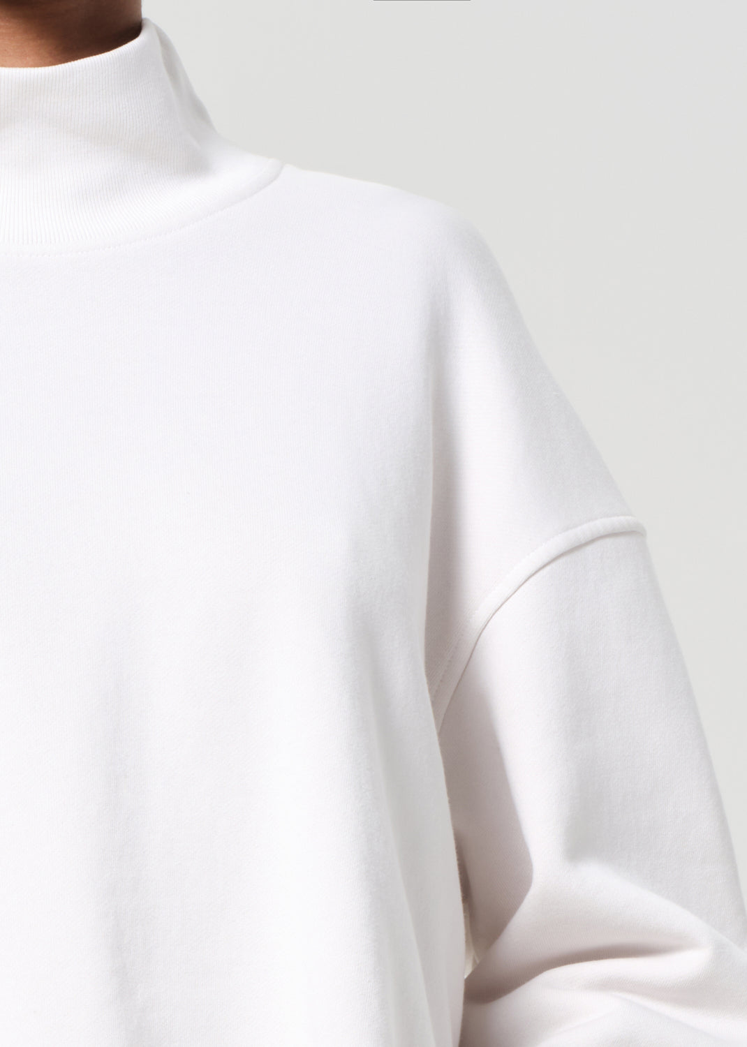 White long-sleeve top on a plain background