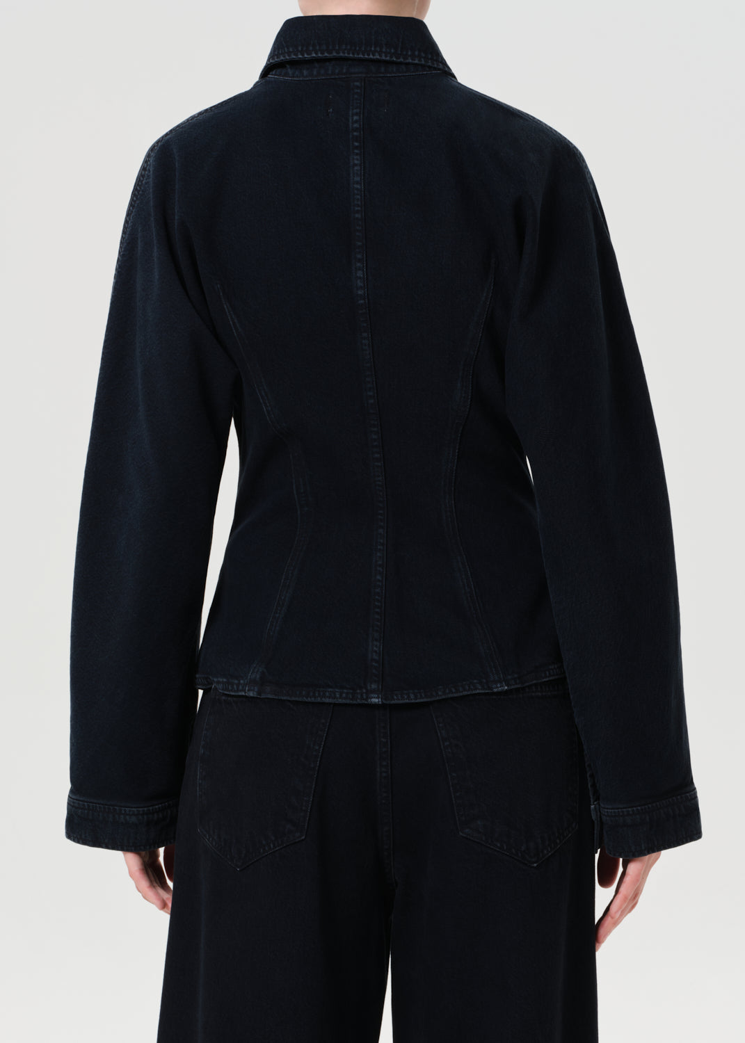 Black jacket worn by a person on a white background