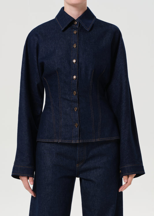 Dark denim jacket and pants on a plain background