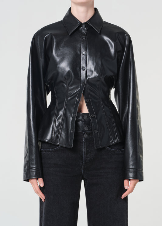 Person wearing a black leather jacket on a plain background