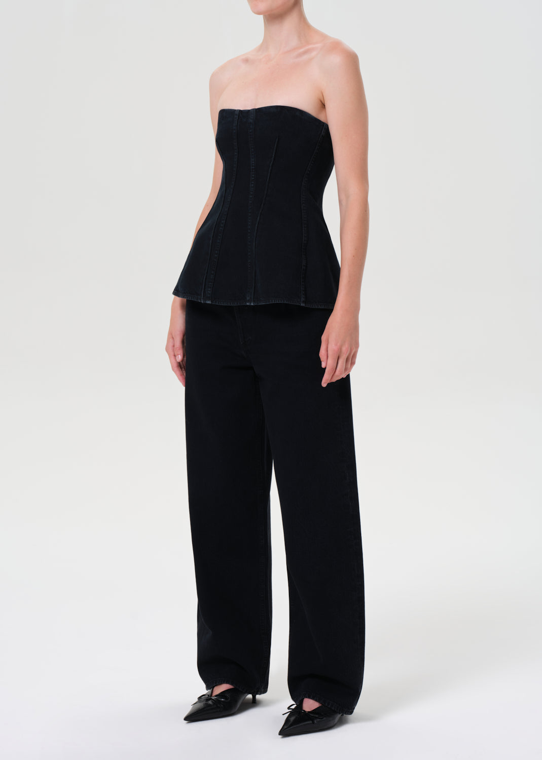 Black strapless top and wide-leg pants on a white background