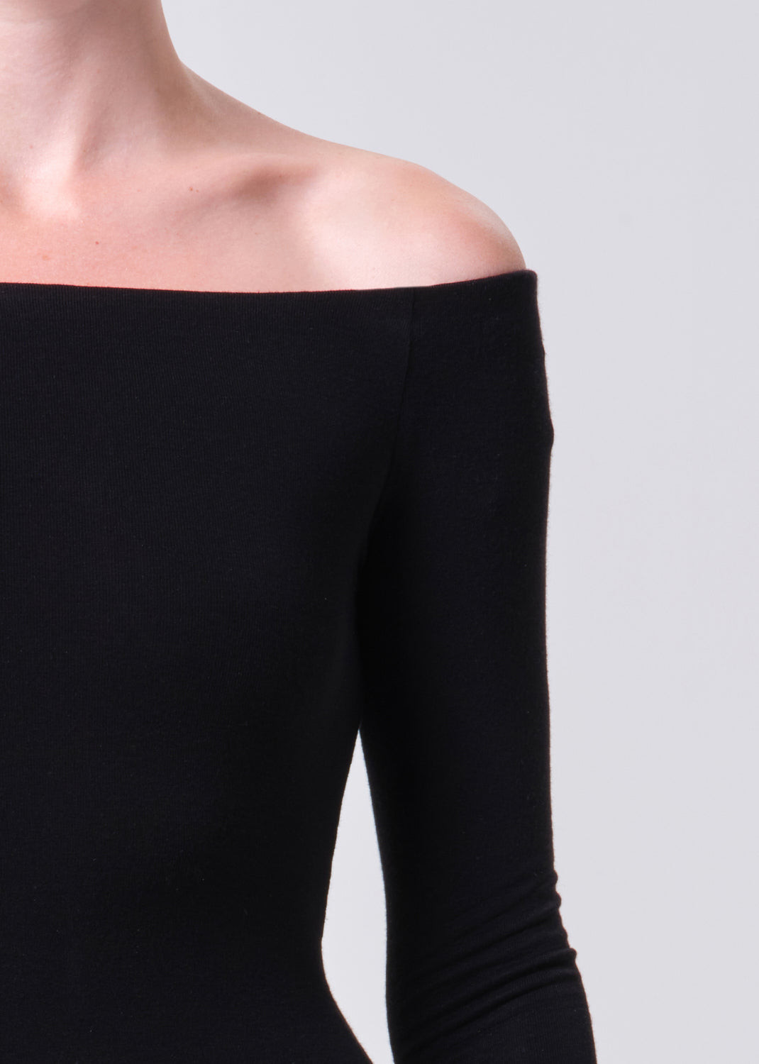 Black off-shoulder top on a plain background