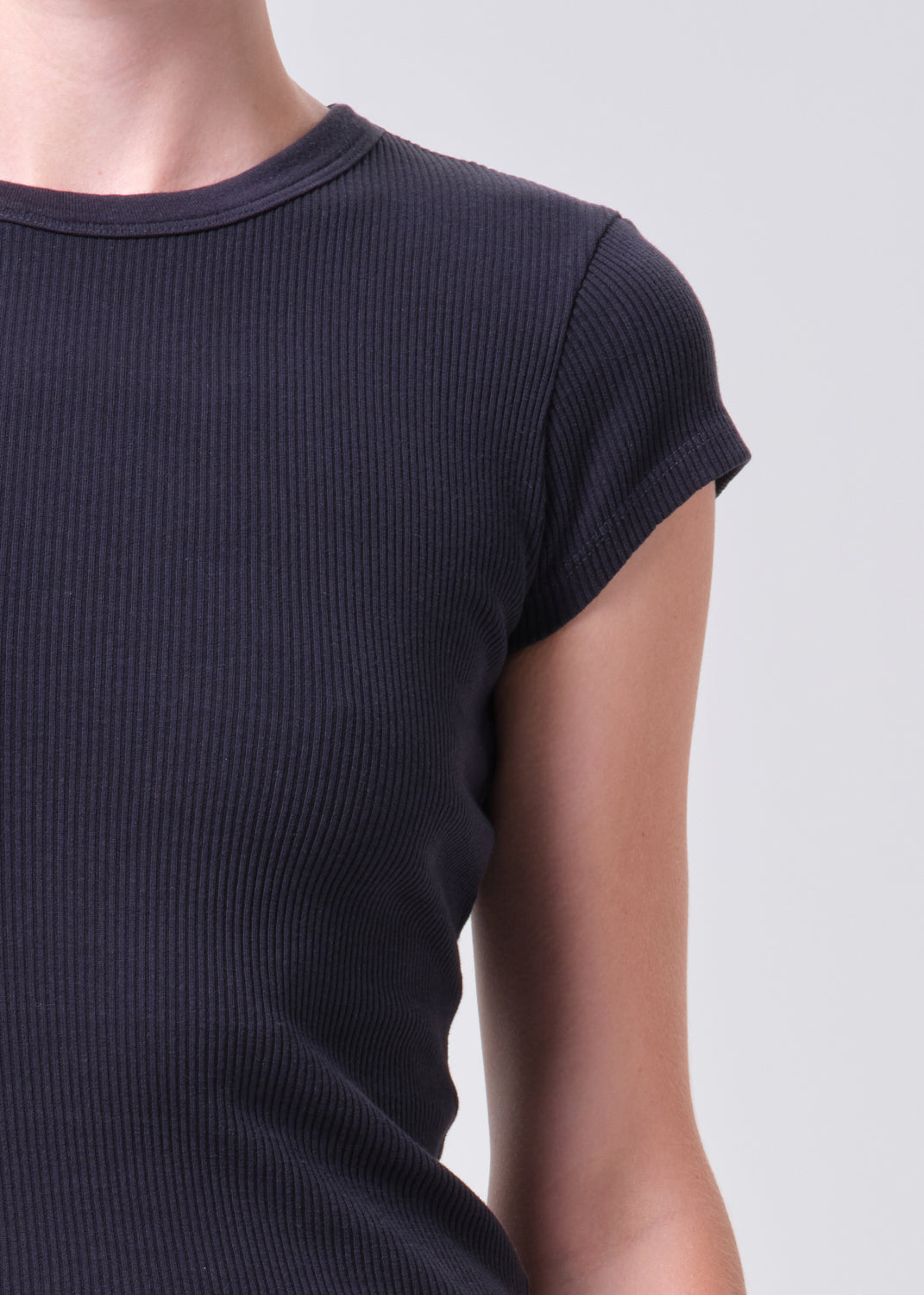 Navy ribbed knit t-shirt worn by a person on a light gray background