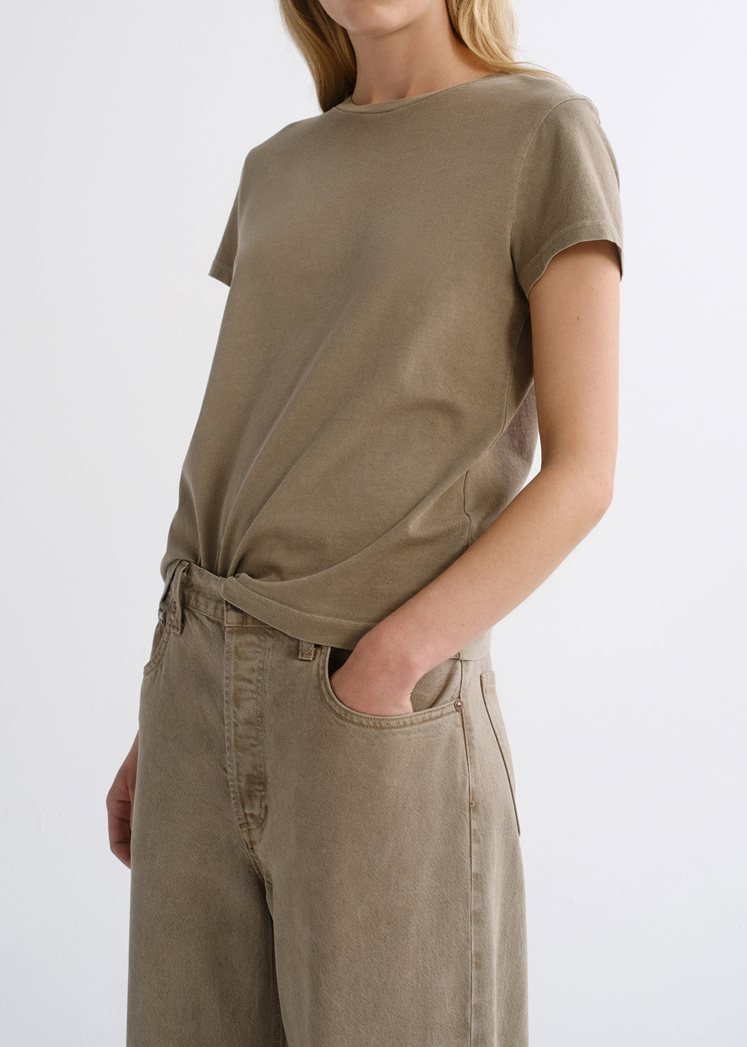 Close up of tan top on a grey background