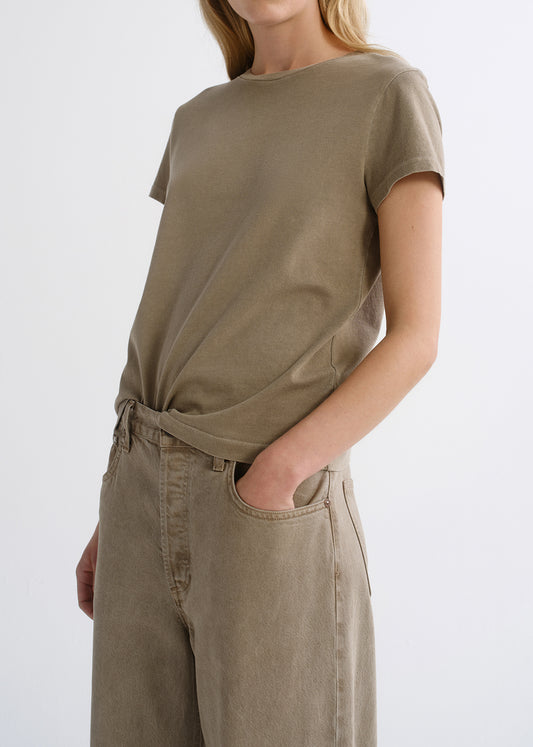 Close up of tan top on a grey background