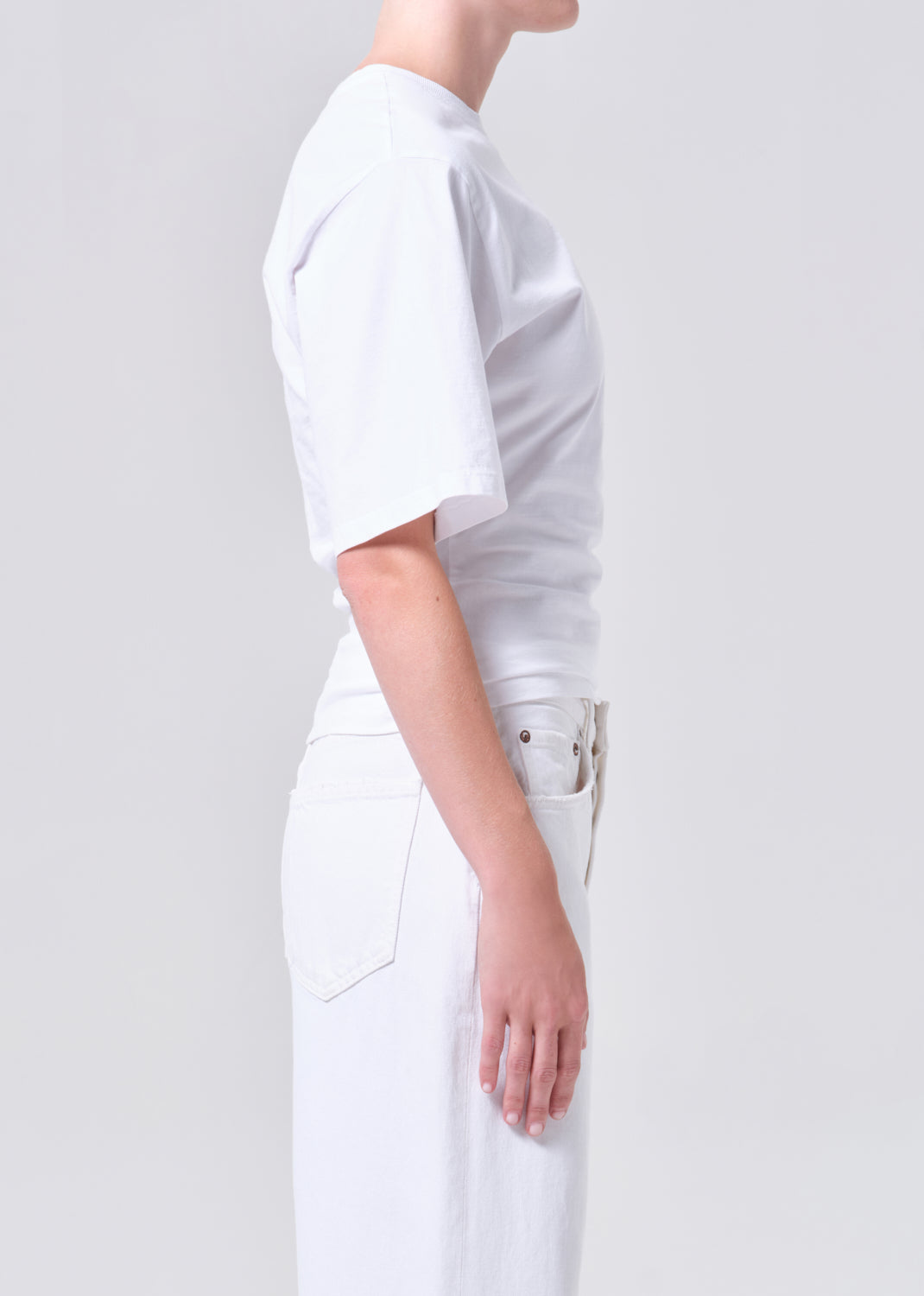 Person wearing a white outfit on a plain background