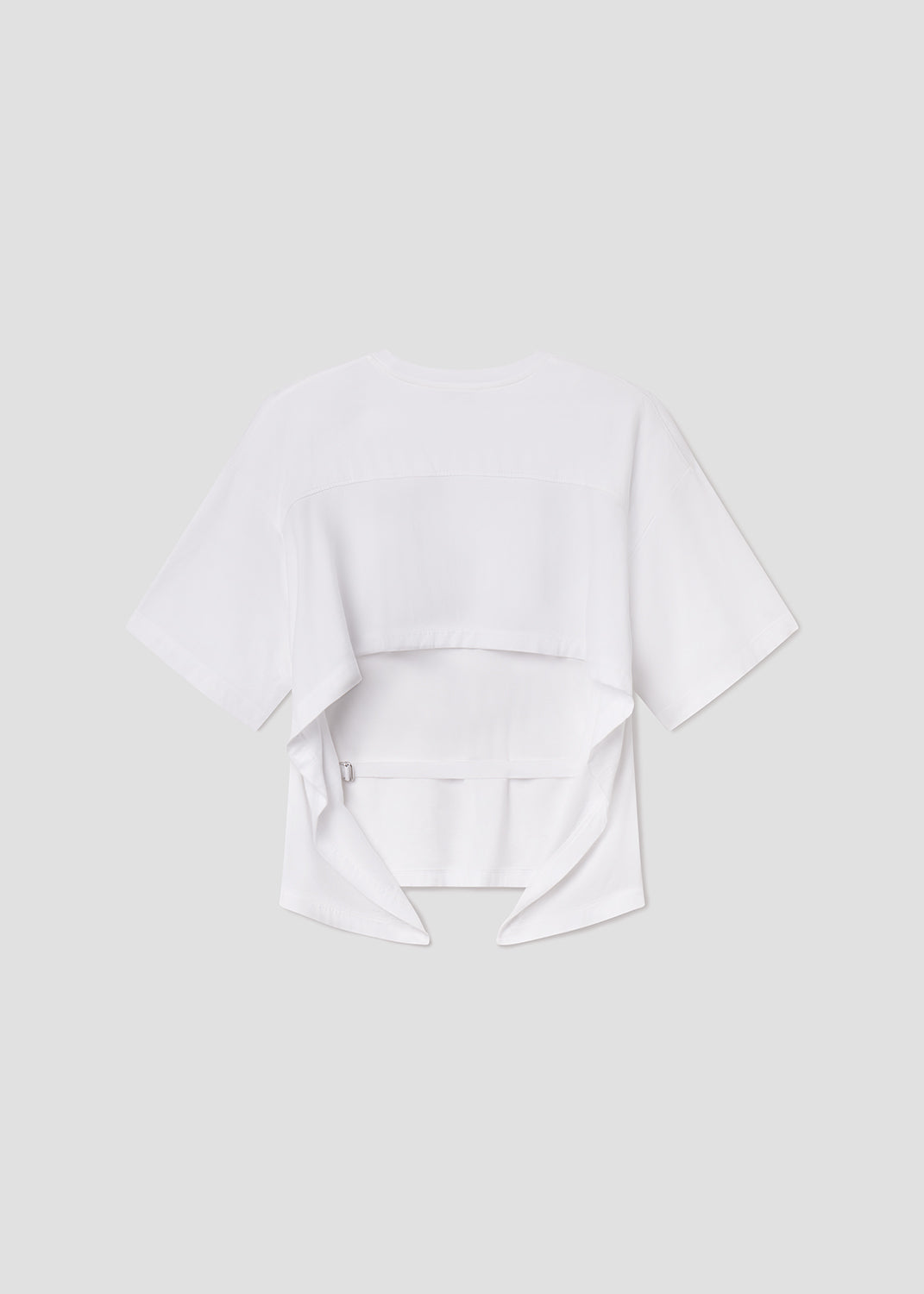 White blouse with ruffled details on a light gray background