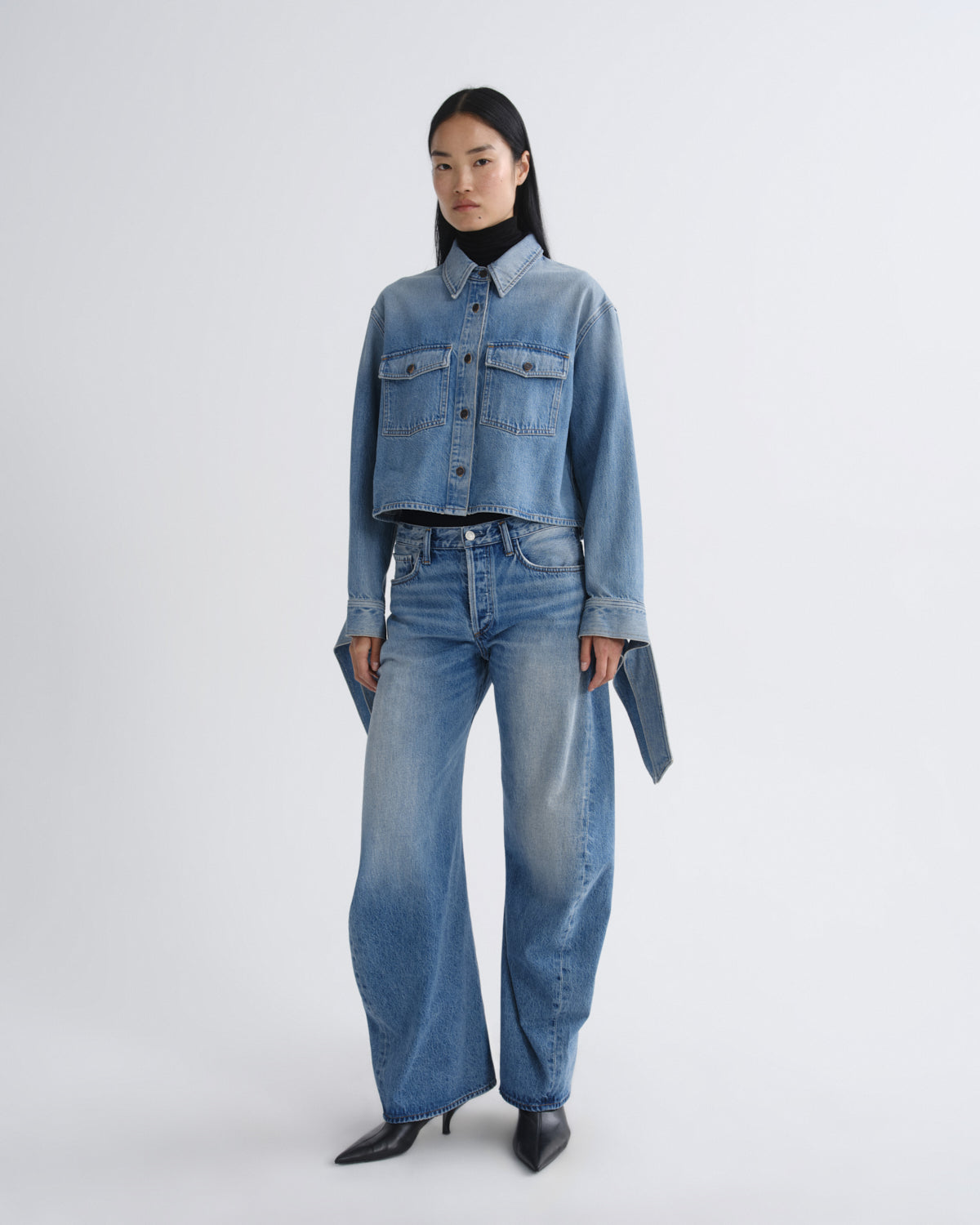 Person wearing a denim outfit on a white background
