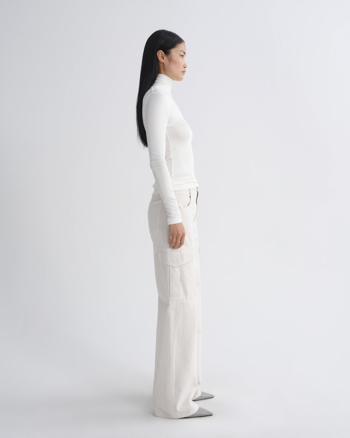 Person wearing a white outfit on a plain background