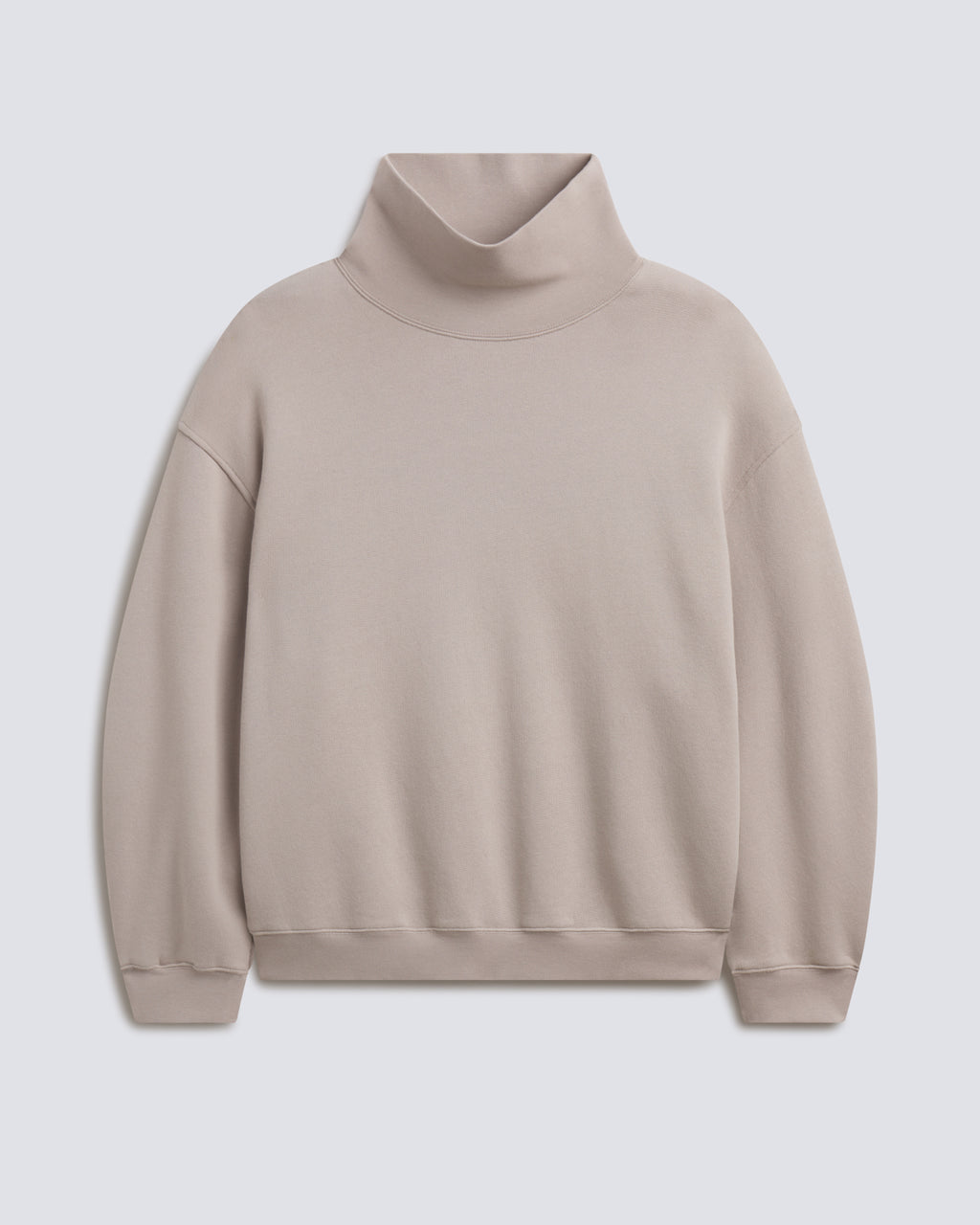 A light beige turtleneck sweatshirt with a relaxed fit, displayed on a neutral light gray background.