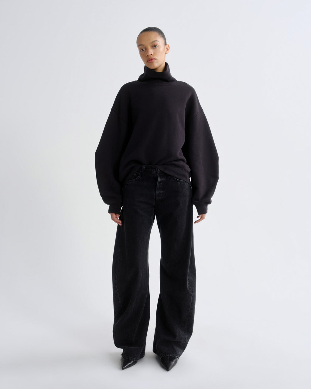 Person wearing a black outfit on a white background