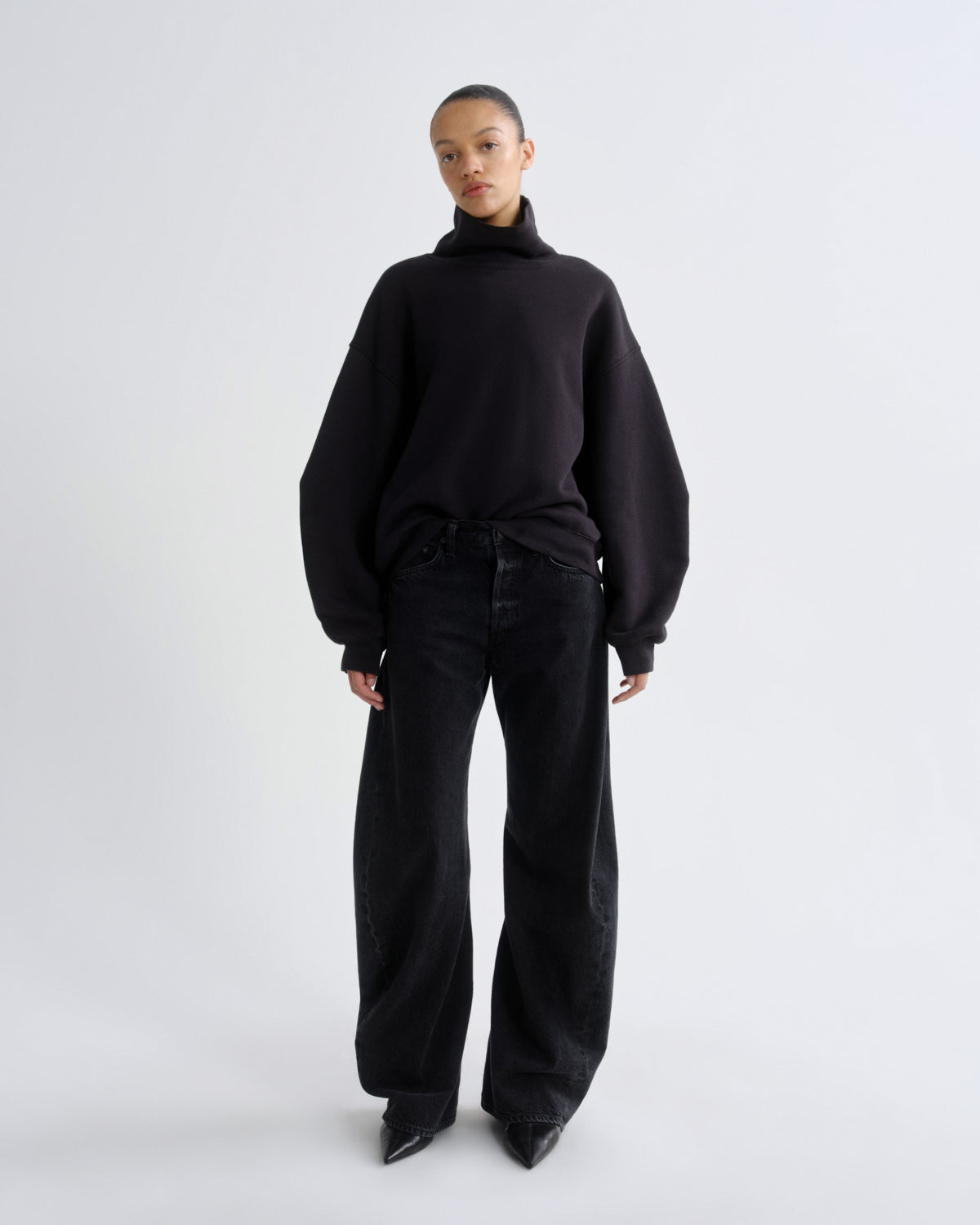 Person wearing a black outfit on a white background
