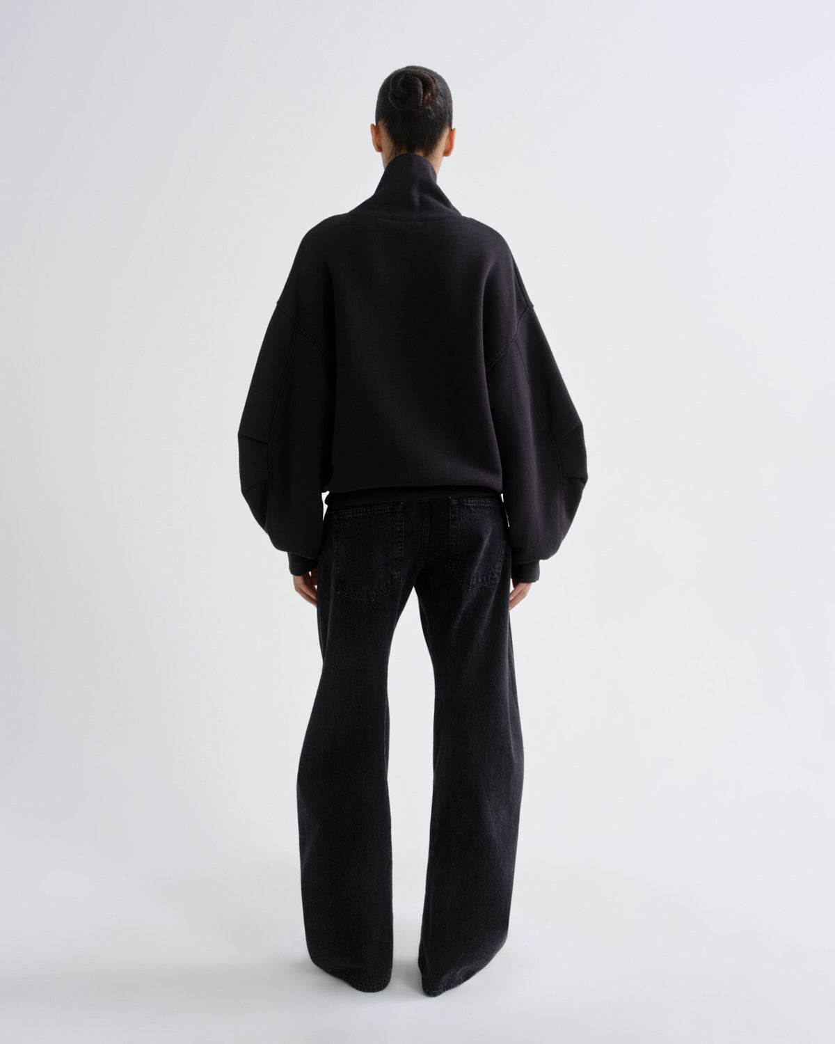 Person wearing a black outfit on a white background