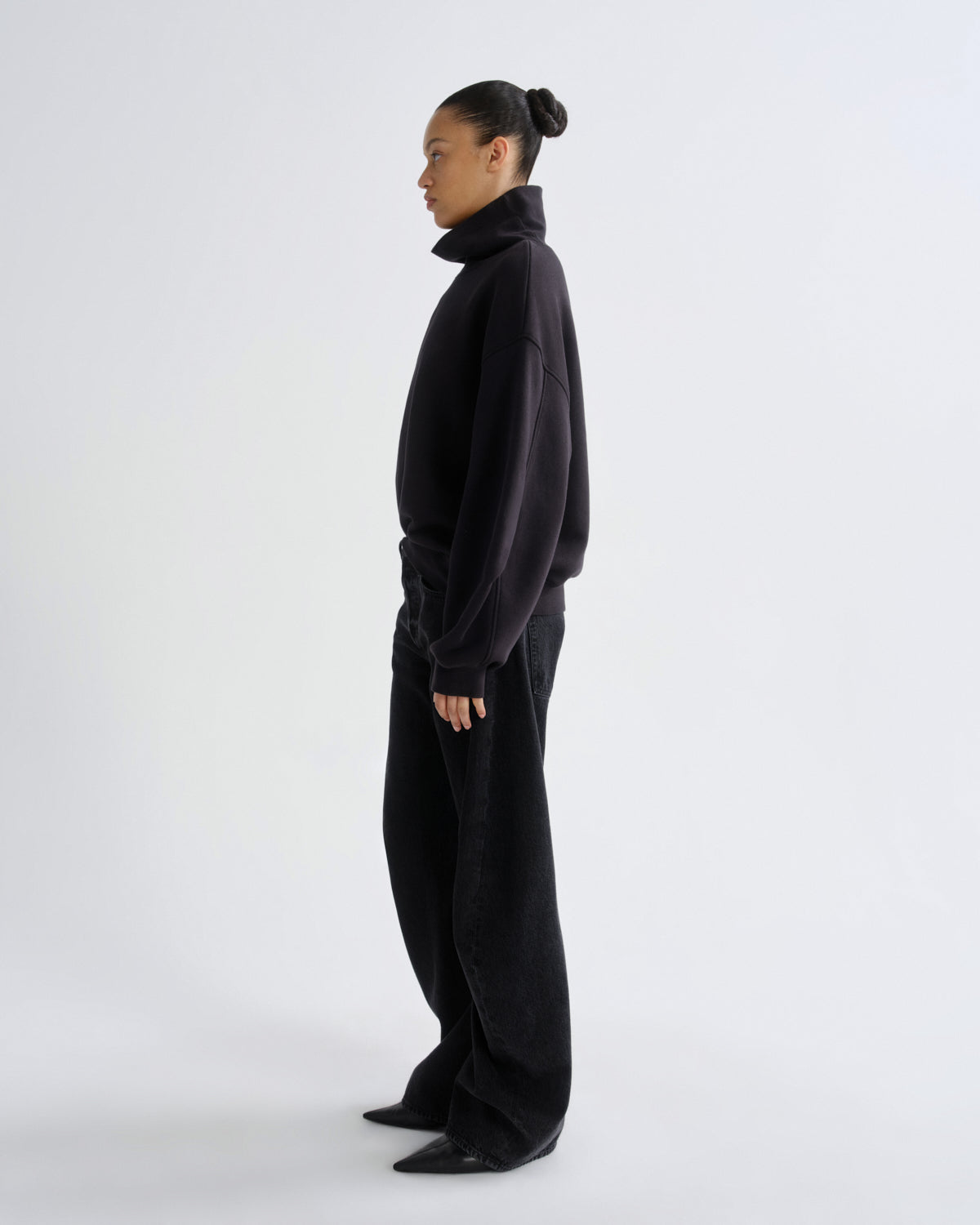 Person wearing a black outfit on a white background