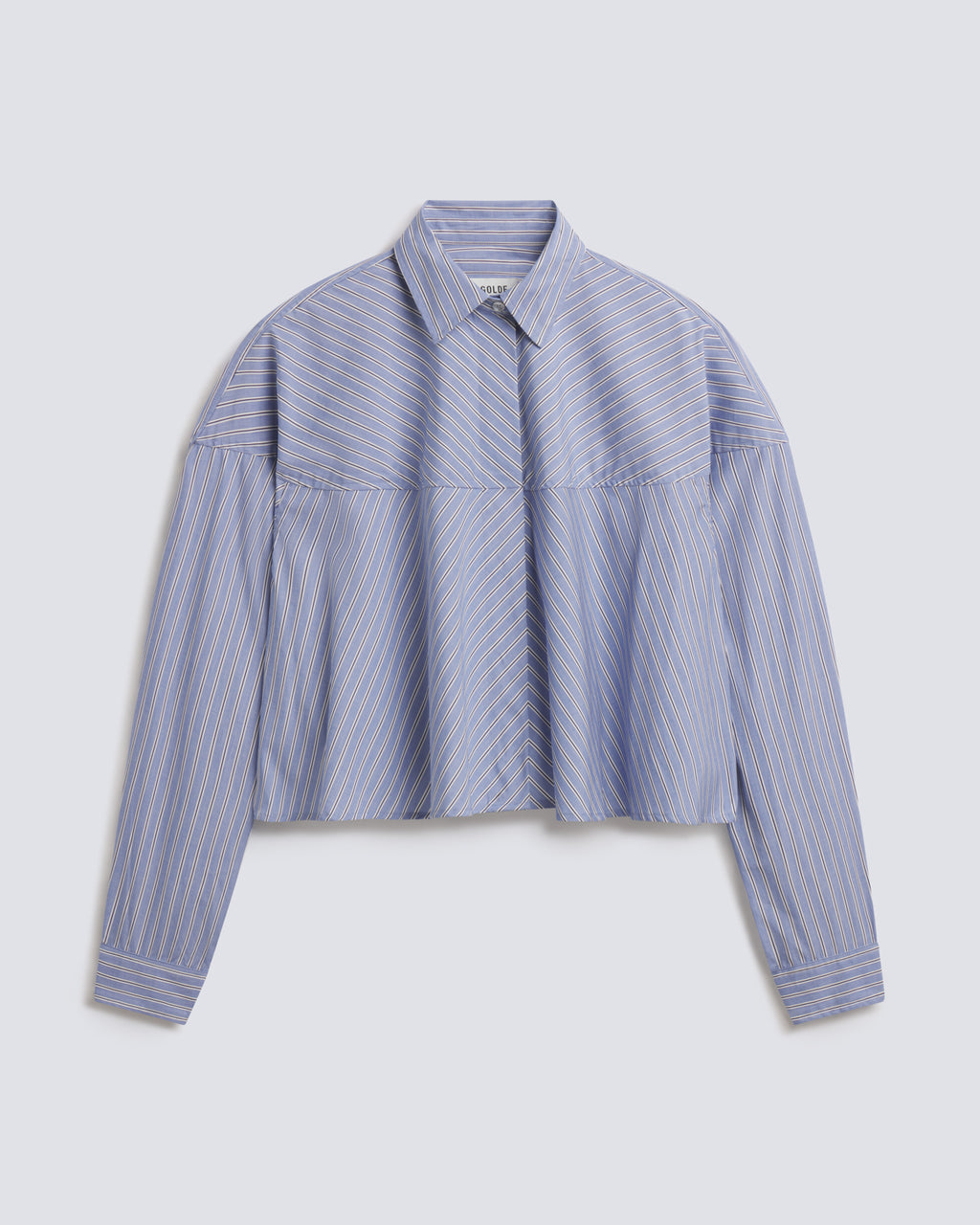 A cropped long-sleeve button-up shirt with a blue and white vertical stripe pattern, featuring a structured collar and a unique horizontal seam design across the chest and shoulders, displayed on a light gray background.