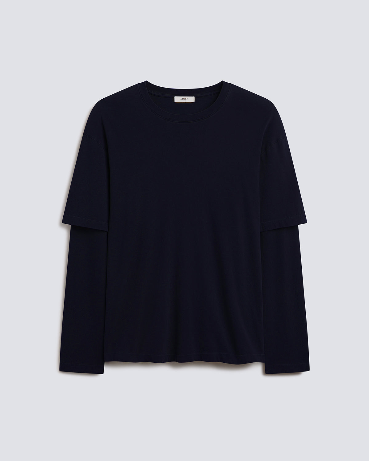A dark navy blue long-sleeve crewneck top with a layered, slightly flared sleeve design, displayed flat against a light gray background.