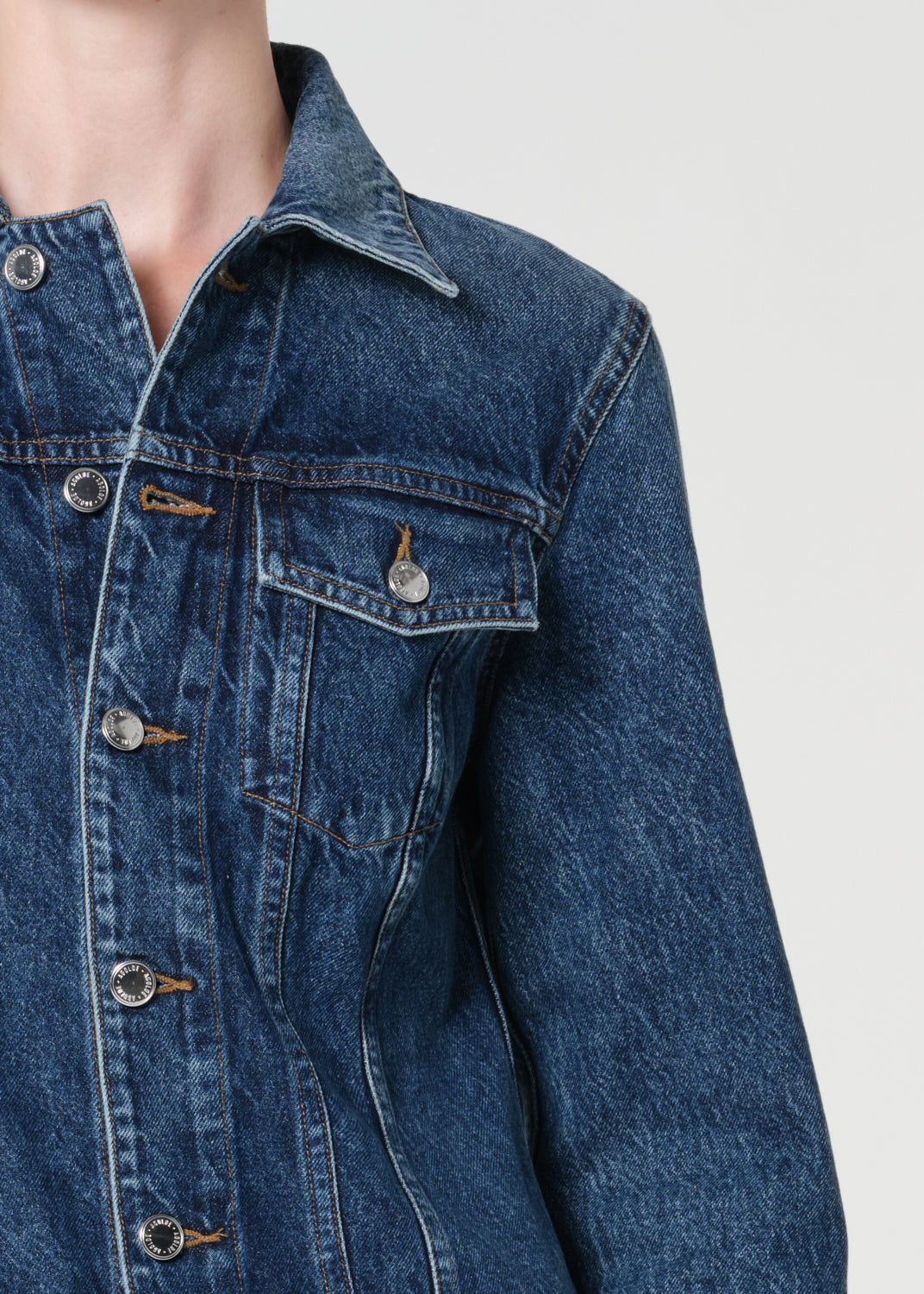 Close-up of a blue denim jacket on a plain background