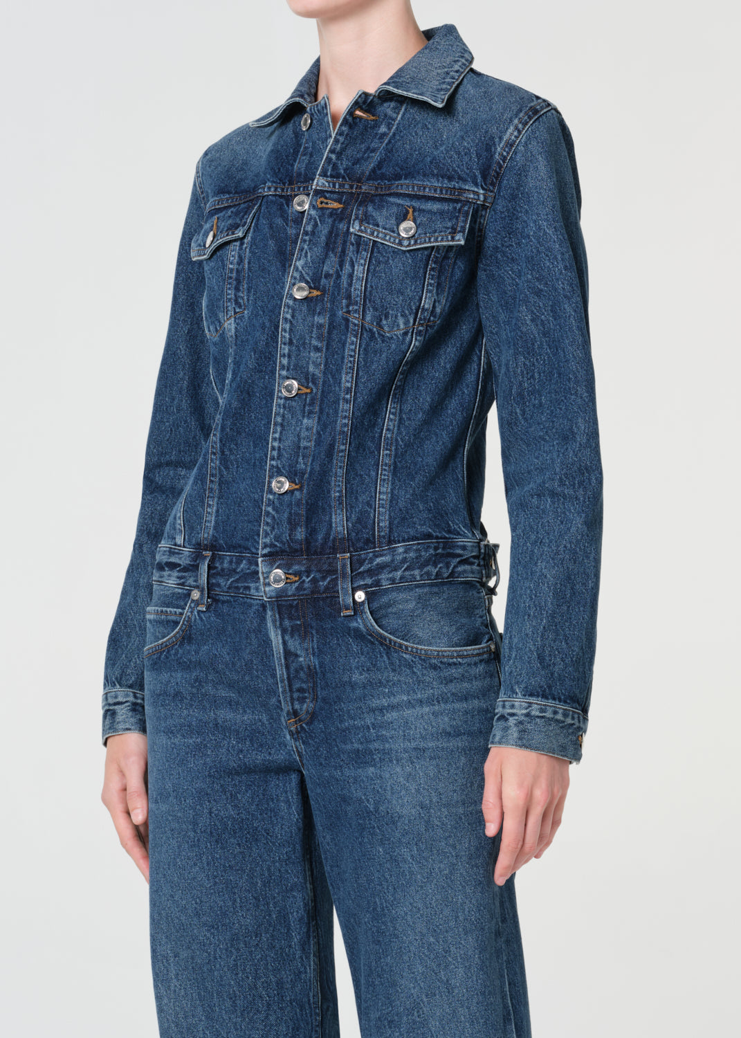 Denim jumpsuit on a plain background