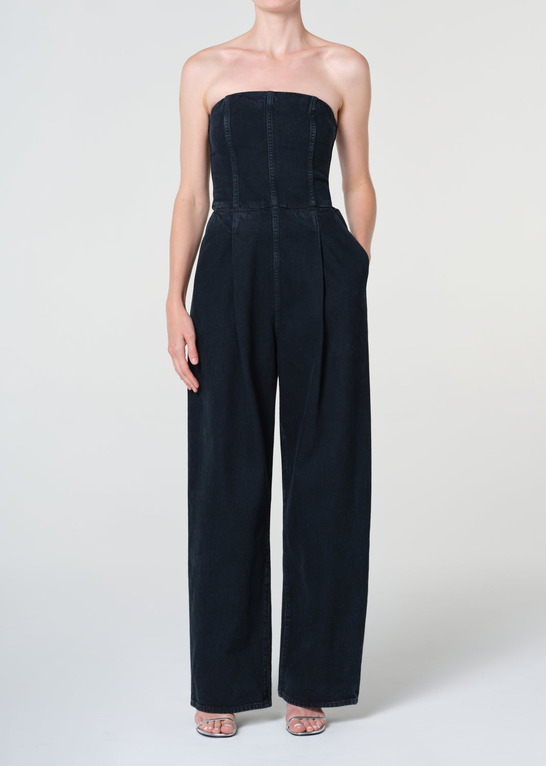 Navy strapless jumpsuit worn by a model on a white background