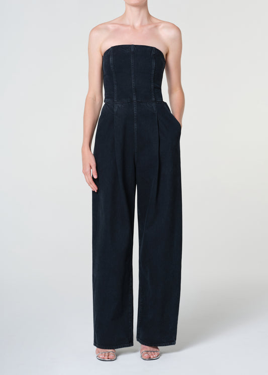 Navy strapless jumpsuit worn by a model on a white background