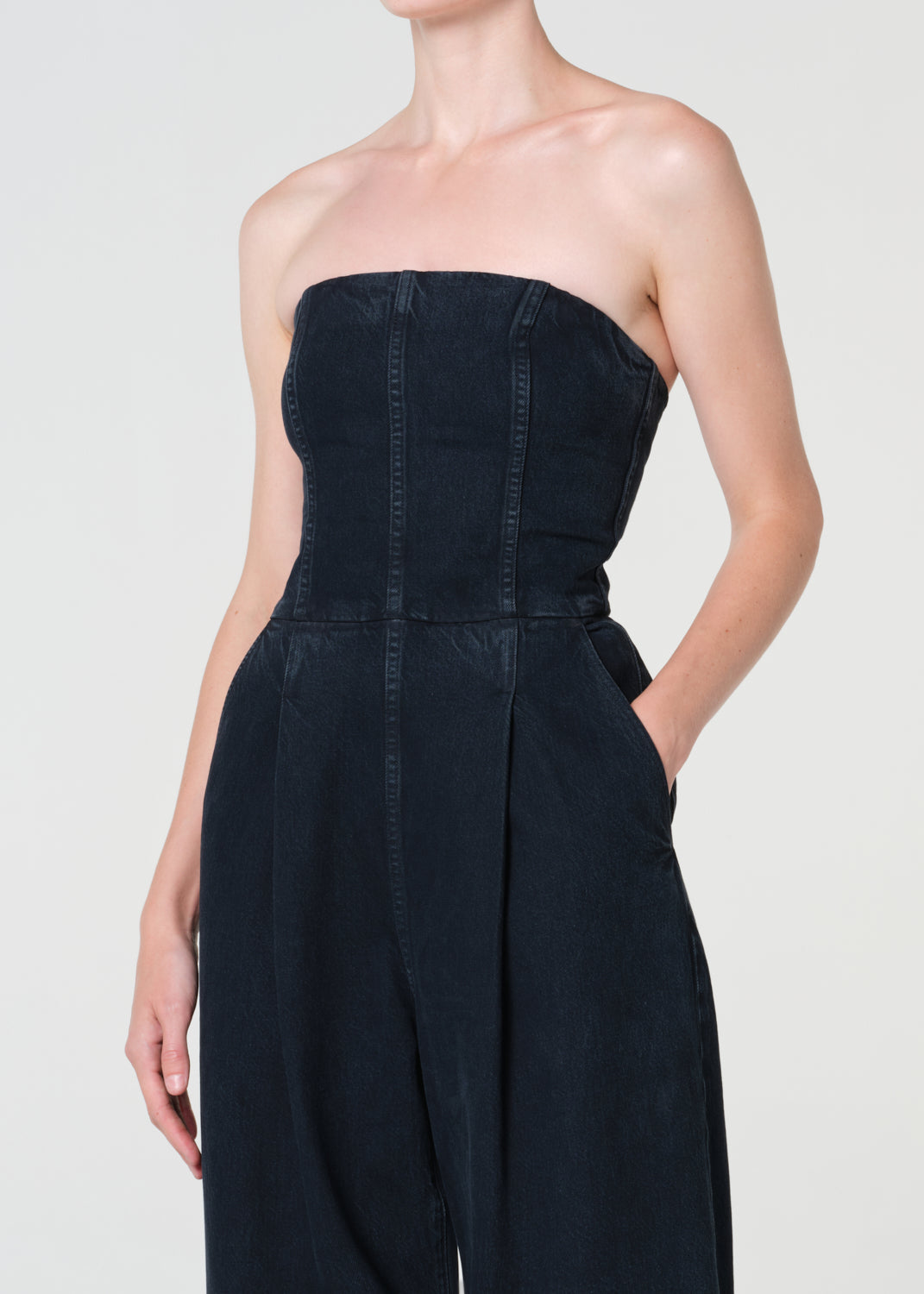 Black strapless jumpsuit worn by a model on a plain background