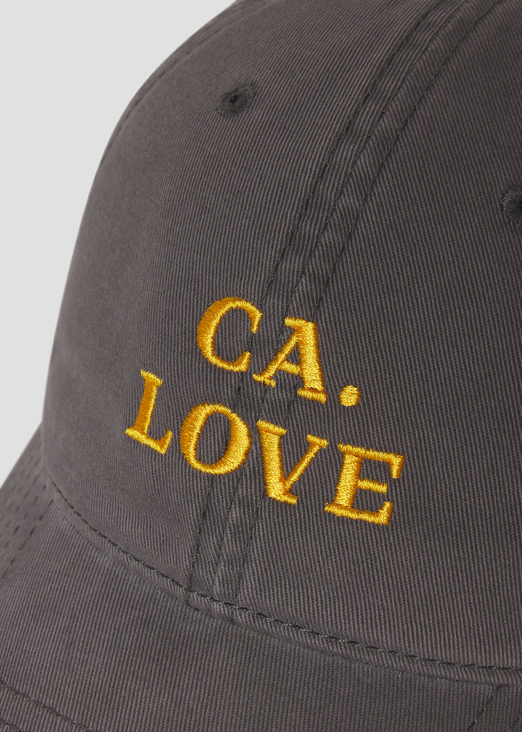 Gray cap with 'CA. LOVE' embroidered in yellow on a light gray background