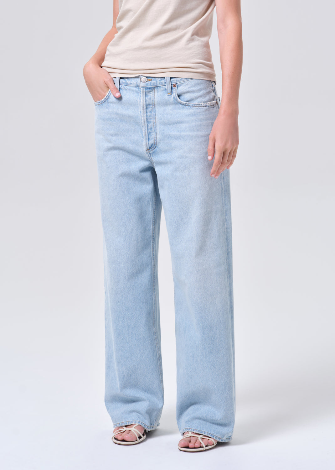 Light blue jeans worn by a person on a white background