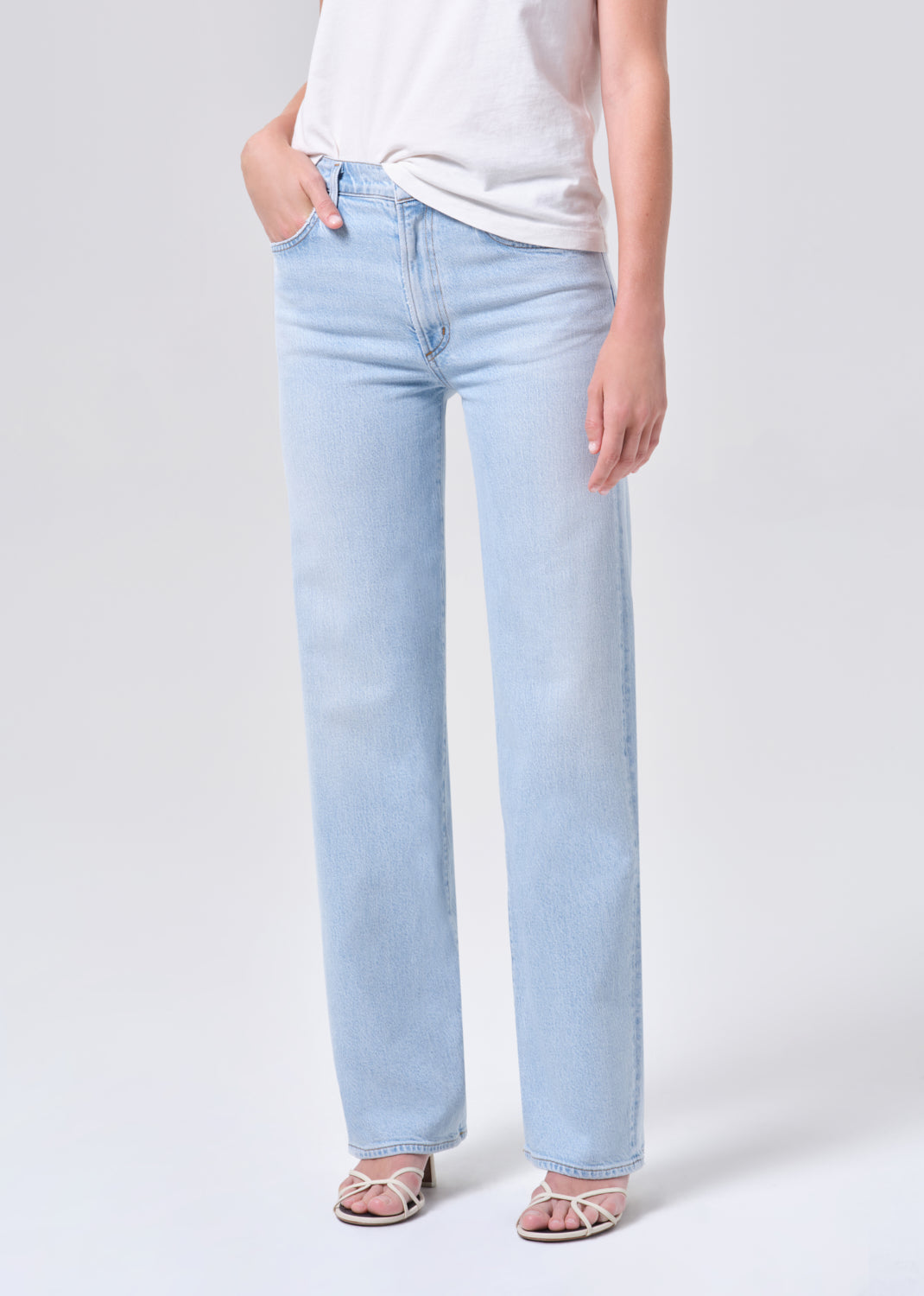 Light blue jeans worn by a person on a white background