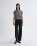 Person wearing a gray t-shirt and black jeans on a white background