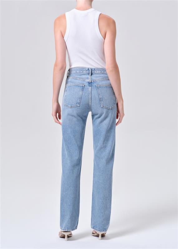 Light blue jeans worn by a person on a white background