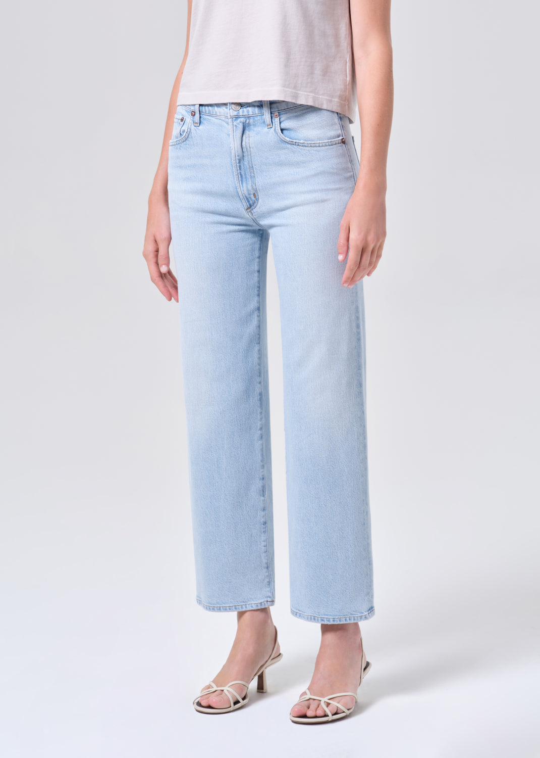 Light blue jeans worn by a person on a white background