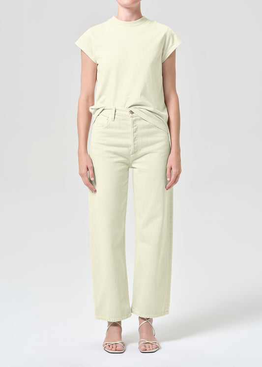 Person wearing a light green outfit on a white background