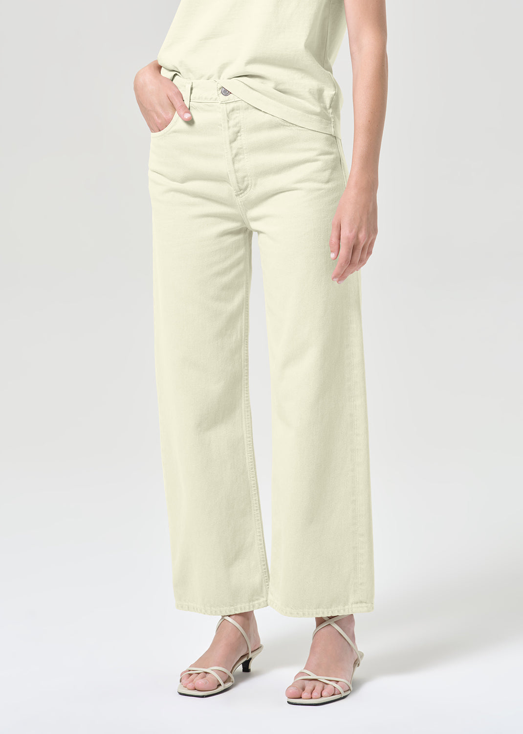 Light-colored pants worn by a person on a white background