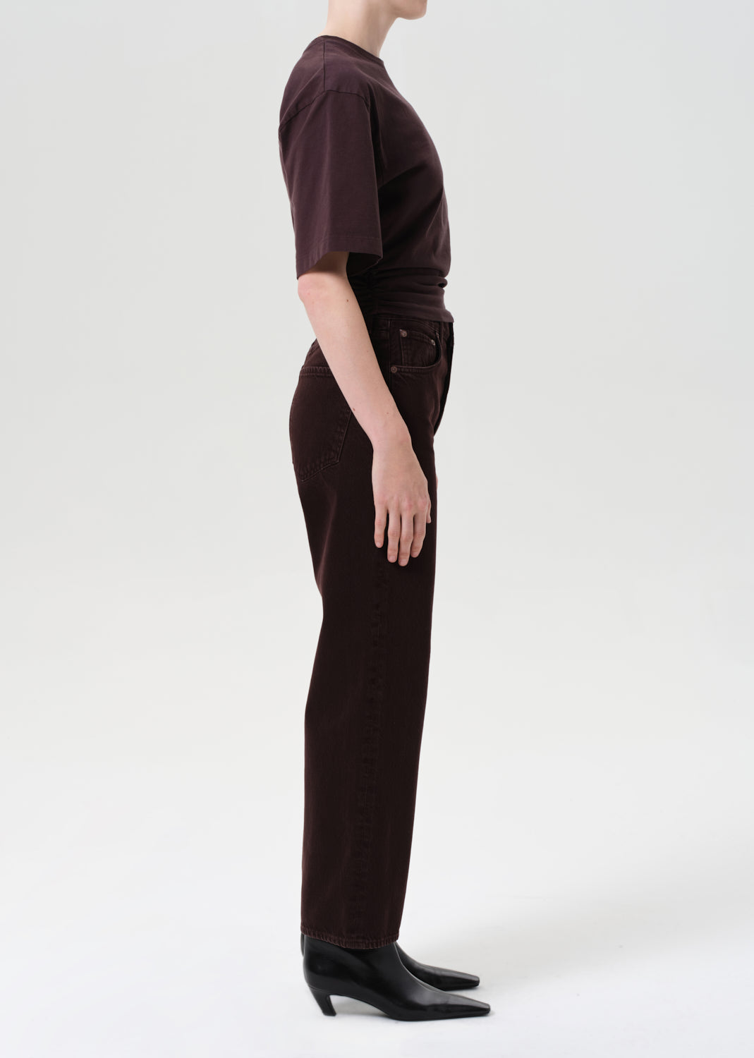 Person wearing a brown outfit with a white background