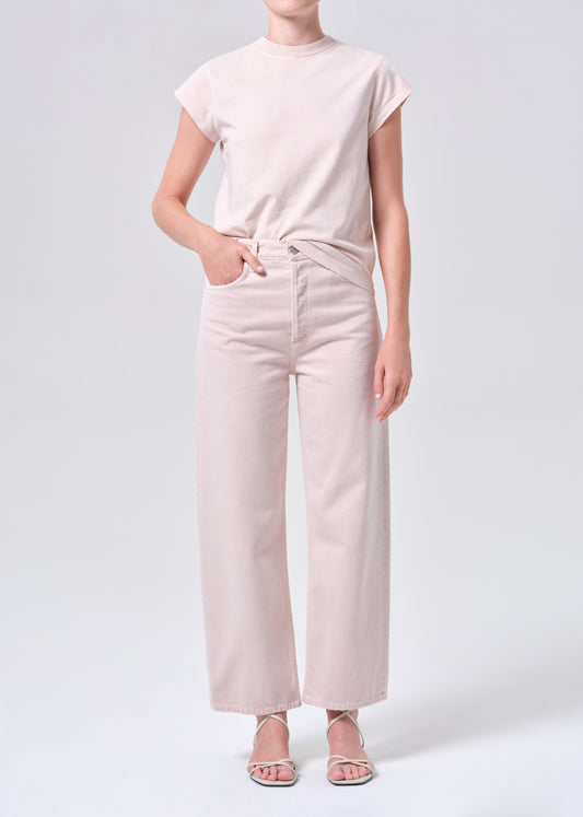 Person wearing a light pink t-shirt and pants on a white background