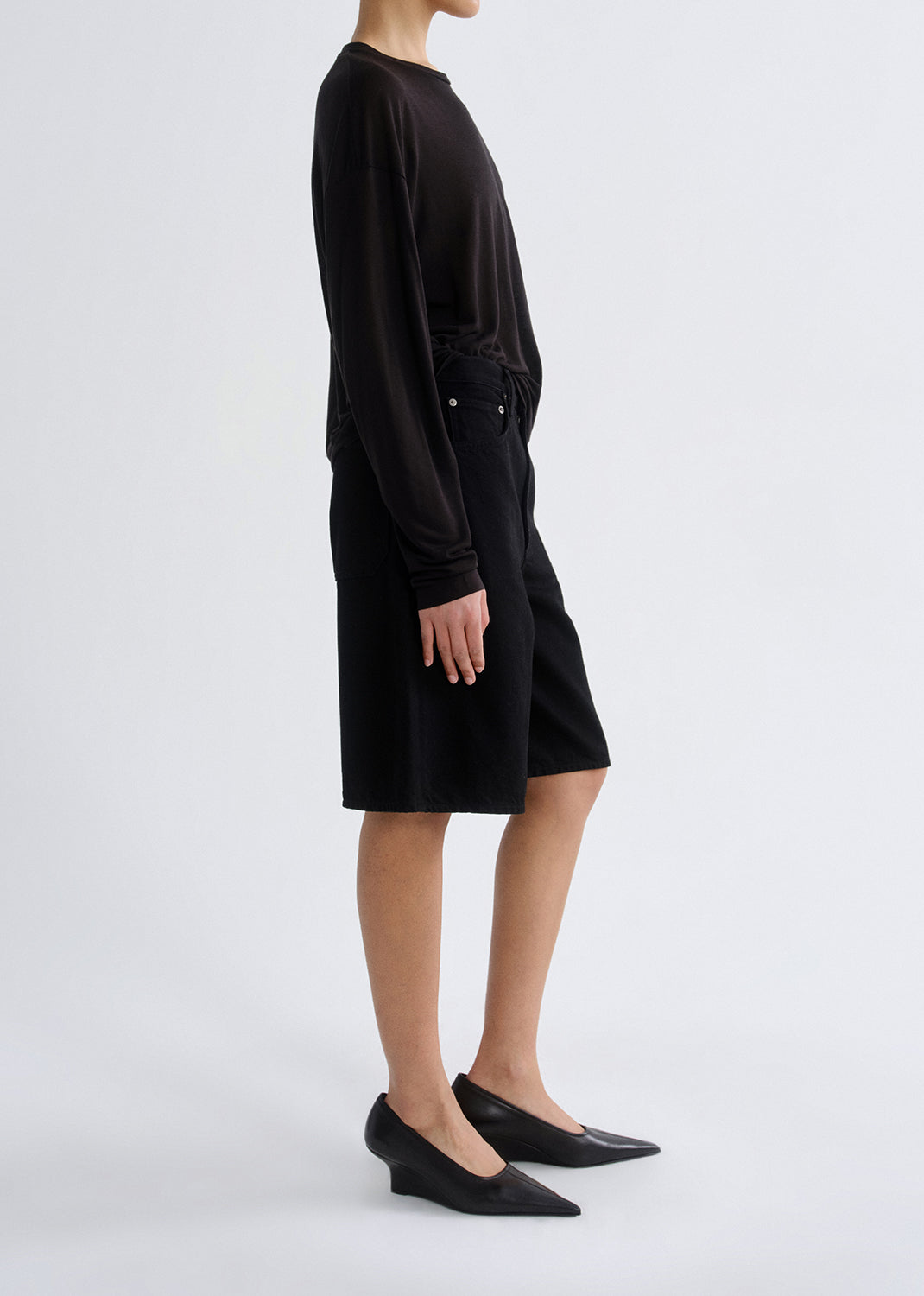 Person wearing a black dress on a white background