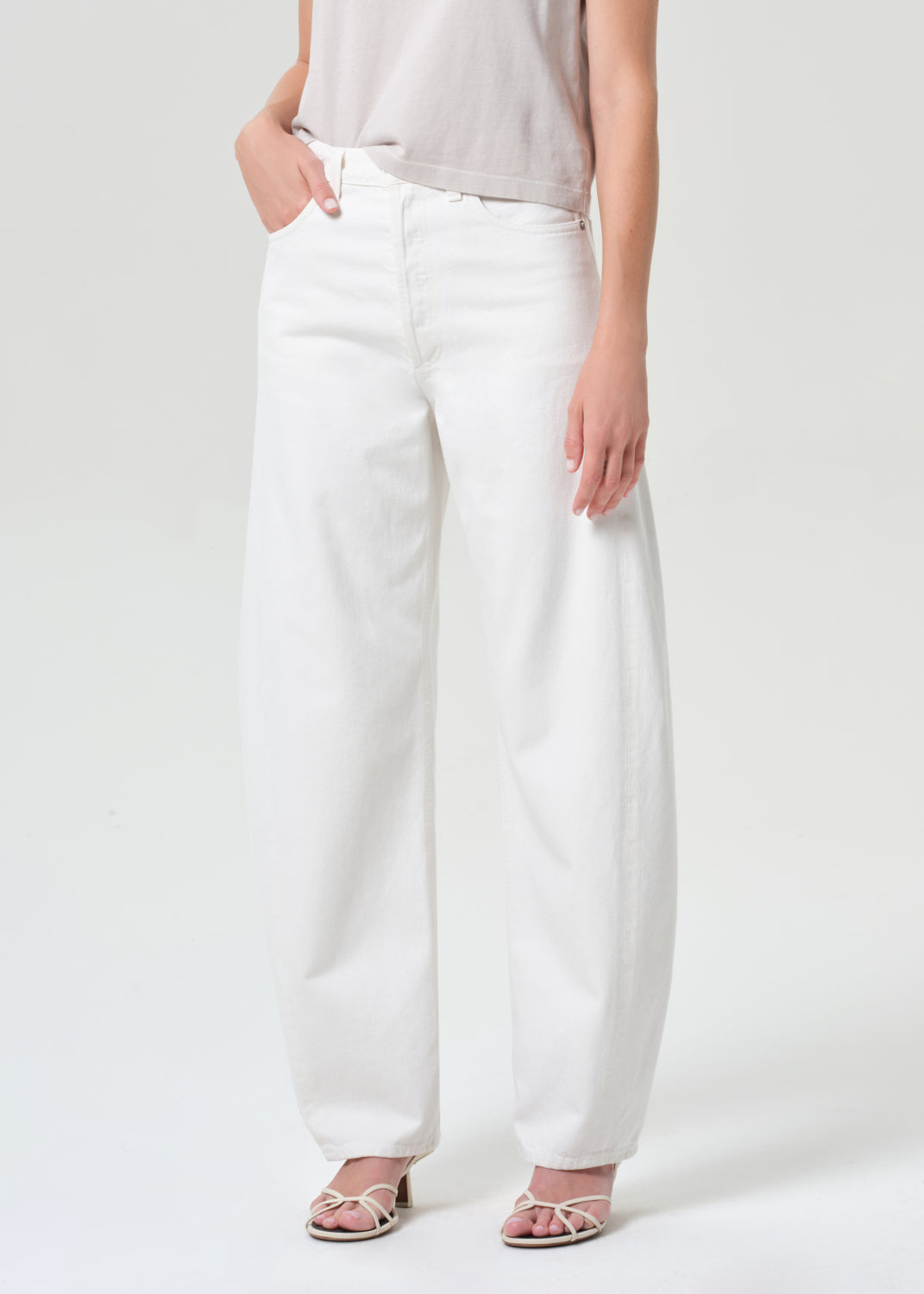 Person wearing white pants on a plain background