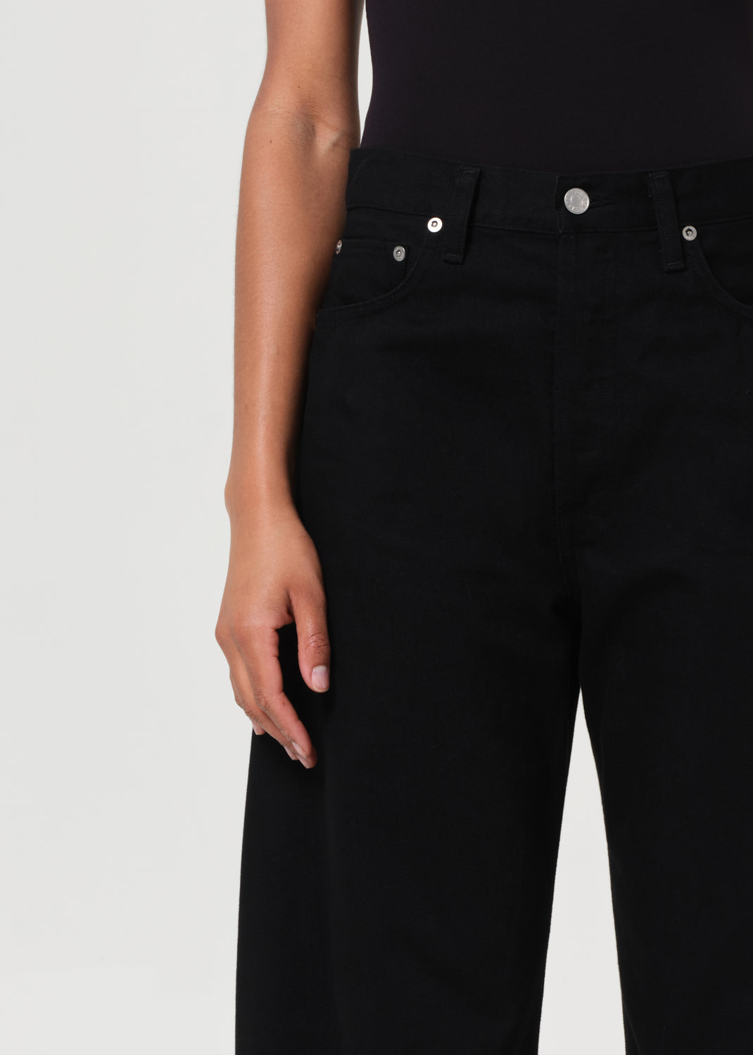Black jeans worn by a person on a light gray background