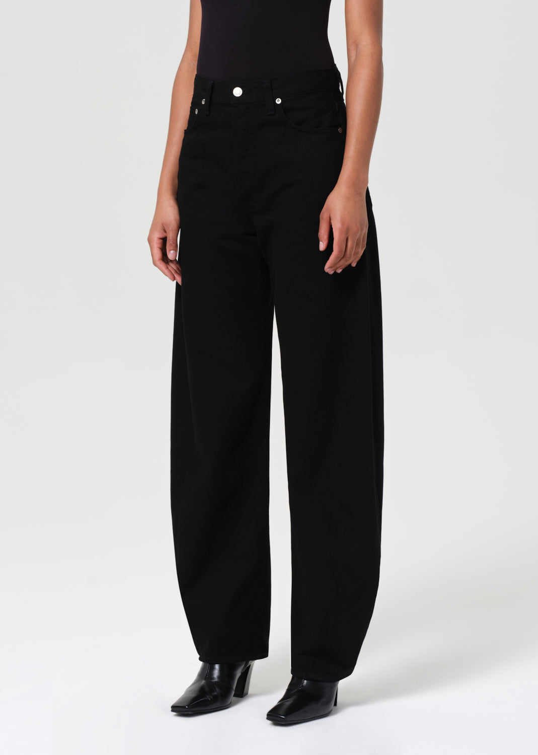 Person wearing black high-waisted pants on a white background