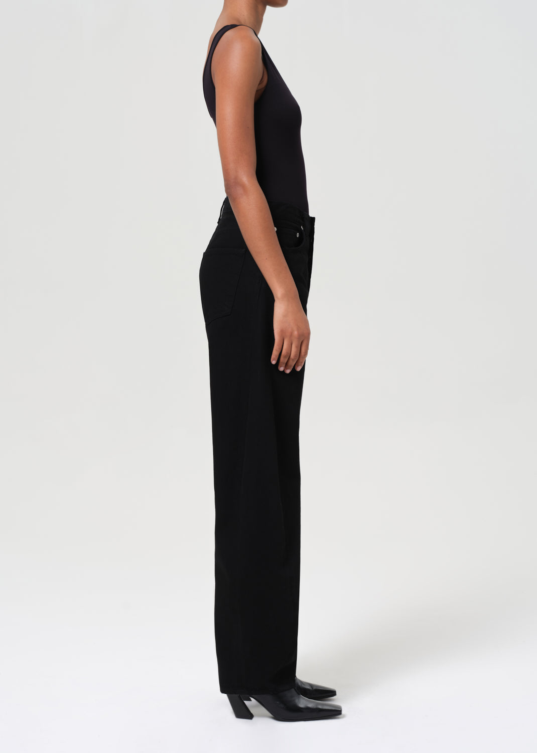 Person wearing a black jumpsuit on a white background