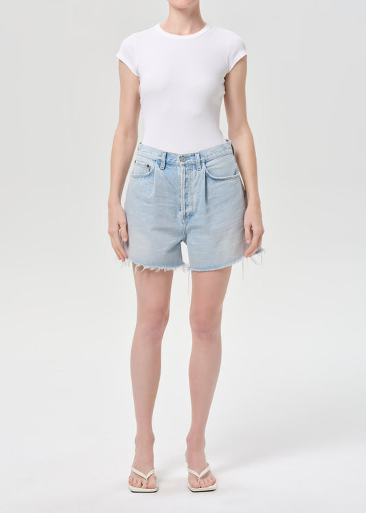 Person wearing a white t-shirt and light blue denim shorts on a white background