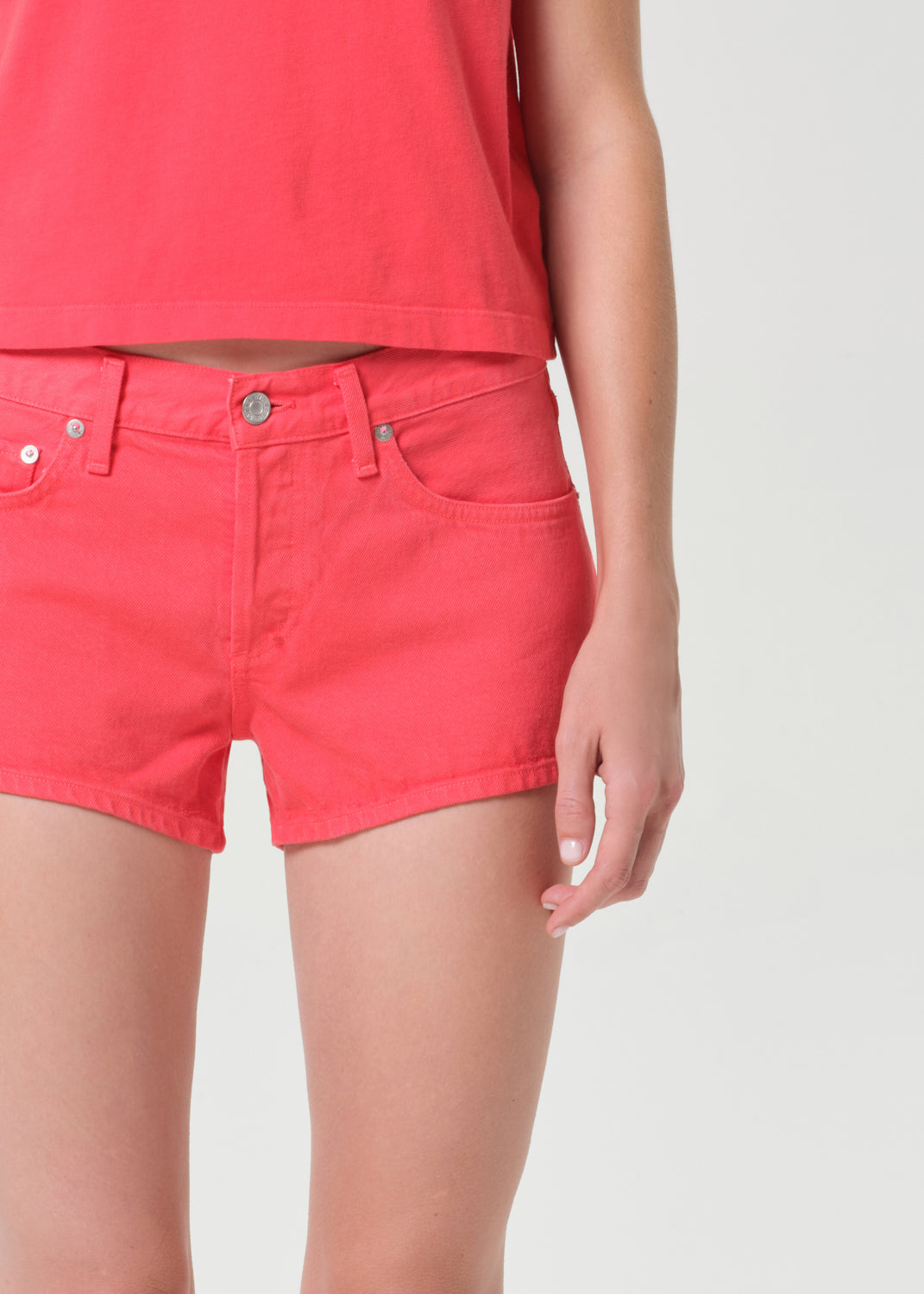 Person wearing red shorts on a plain background