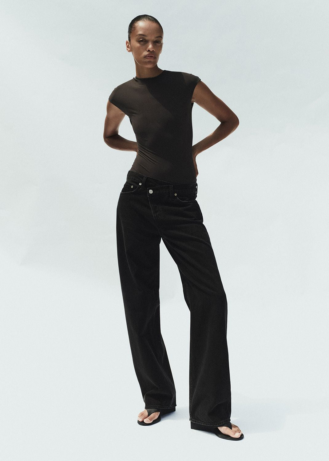 Person wearing a black outfit on a white background